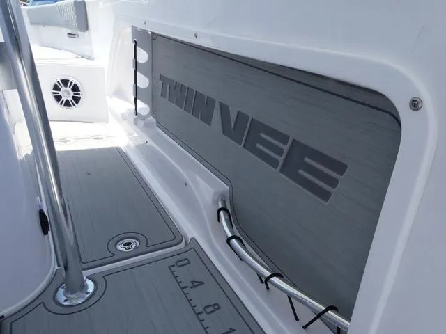 Slide: The Image of 2025 Twin Vee 240 Center Console STX with dual Suzuki 150 engines, rear view. - 6
