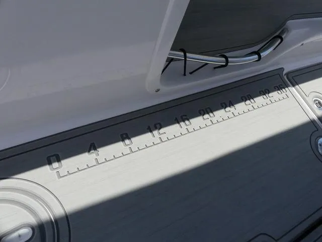 Slide: The Image of 2025 Twin Vee 240 Center Console STX boat with dual Suzuki 150 engines on a trailer. - 7