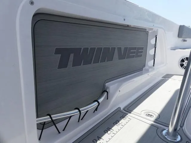 Slide: The Image of 2025 Twin Vee 240 Center Console STX boat interior with steering wheel and seating. - 8