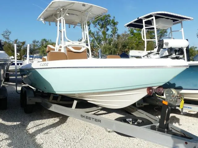 Slide: The Image of 2019 Skeeter SX2250 boat on trailer, light blue hull, parked outdoors. - 1