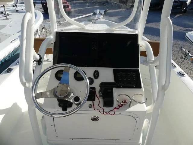 Slide: The Image of 2019 Skeeter SX2250 boat console with steering wheel and electronic controls. - 11