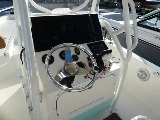 Slide: The Image of 2019 Skeeter SX2250 boat console with steering wheel and navigation controls. - 12