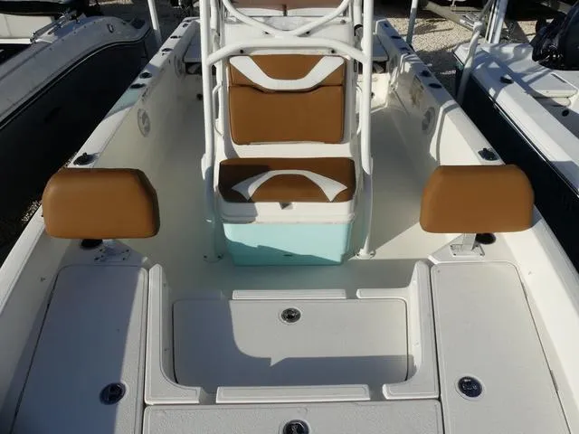 Slide: The Image of 2019 Skeeter SX2250 boat interior with brown seating and white deck. - 17