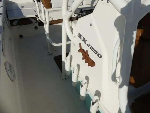 Slide: The Image of 2019 Skeeter SX2250 boat interior with rod holders and logo detail. - 19