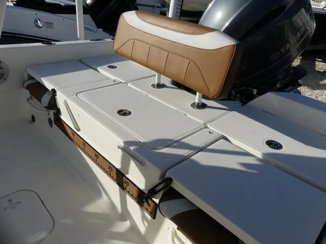 Slide: The Image of 2019 Skeeter SX2250 boat interior with cushioned seating and Yamaha engine. - 21