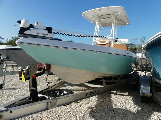 Slide: The Image of 2019 Skeeter SX2250 boat on trailer, light blue hull, parked outdoors. - 3