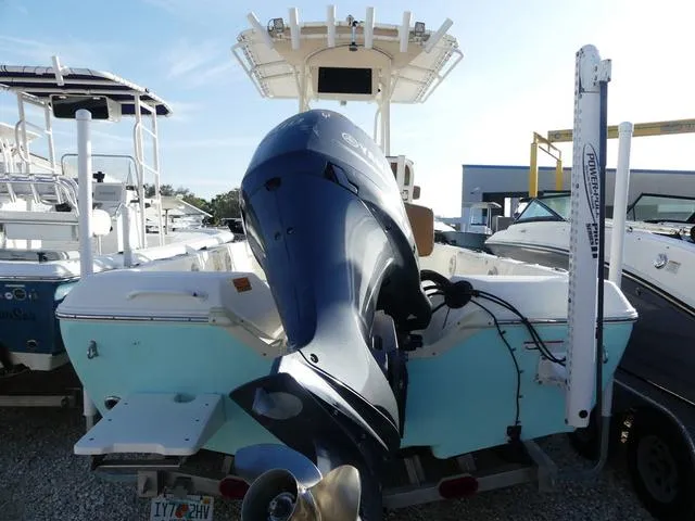 Slide: The Image of 2019 Skeeter SX2250 boat with powerful outboard motor, docked among other vessels. - 5