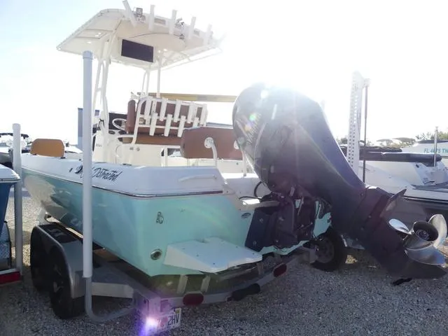 Slide: The Image of 2019 Skeeter SX2250 boat with outboard motor on trailer, parked outdoors. - 6