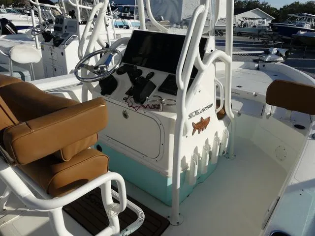 Slide: The Image of 2019 Skeeter SX2250 boat console with brown seating and steering wheel. - 8
