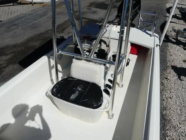 Slide: The Image of 2014 Mako Pro 17 Skiff CC boat interior with seating and console, photographed outdoors. - 10