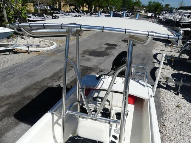 Slide: The Image of 2014 Mako Pro 17 Skiff CC boat with T-top, parked on a trailer. - 11