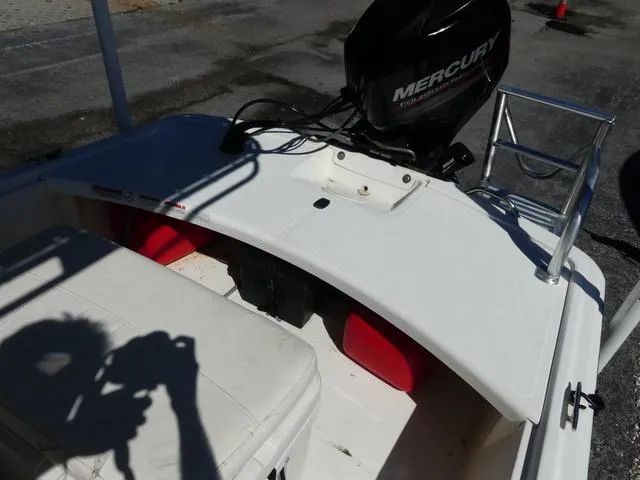 Slide: The Image of 2014 Mako Pro 17 Skiff CC boat with Mercury engine, white seating, and red fuel tanks. - 12