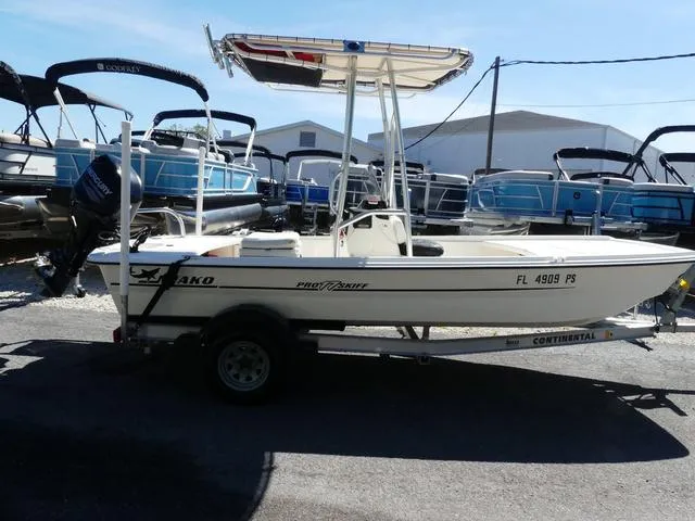 Slide: The Image of 2014 Mako Pro 17 Skiff CC boat on trailer, surrounded by other boats. - 2