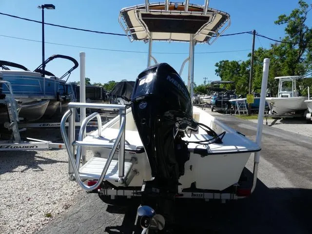 Slide: The Image of 2014 Mako Pro 17 Skiff CC boat with Mercury outboard motor, parked on a trailer. - 4