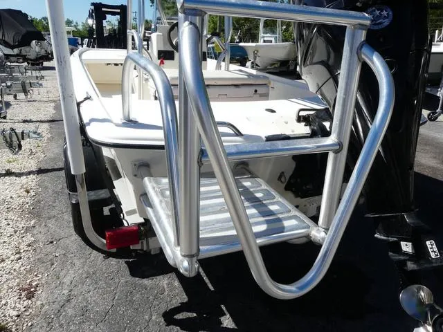 Slide: The Image of 2014 Mako Pro 17 Skiff CC boat with metal ladder and outboard motor. - 6