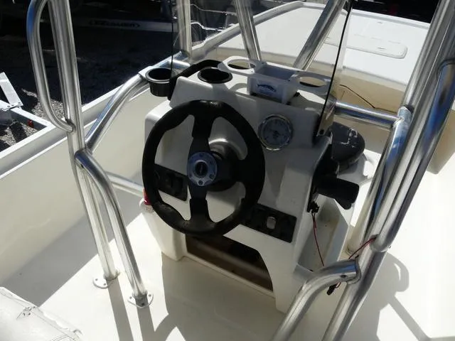 Slide: The Image of 2014 Mako Pro 17 Skiff CC boat console with steering wheel and gauges. - 7