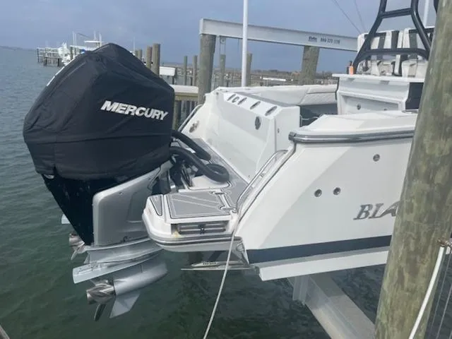 Slide: The Image of 2022 Blackfin 272CC boat with Mercury engine docked at marina. - 4