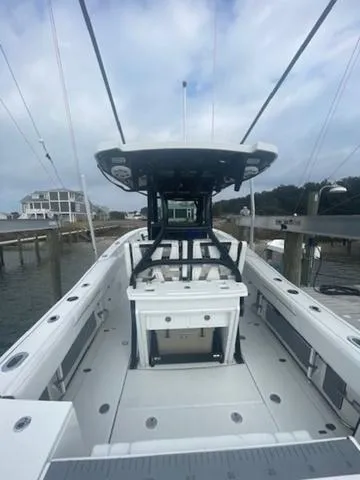 Slide: The Image of 2022 Blackfin 272CC boat docked, showcasing spacious deck and modern design. - 5