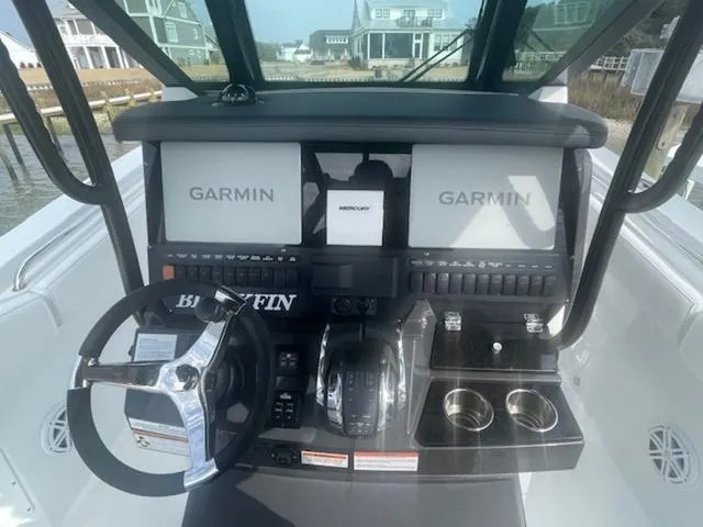 Slide: The Image of 2022 Blackfin 272CC boat dashboard with Garmin displays and steering wheel. - 9