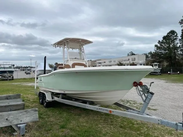 Slide: The Image of 2023 Pioneer 220 Bay Sport boat on trailer, parked outdoors under cloudy sky. - 3