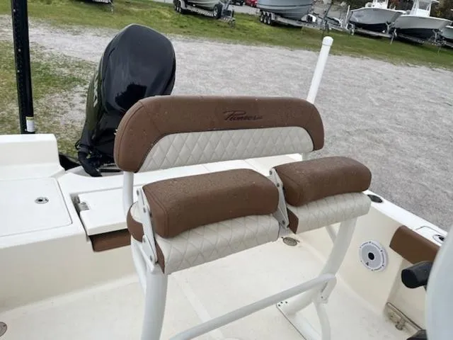 Slide: The Image of 2023 Pioneer 220 Bay Sport boat seating with brown and white cushioned design. - 6