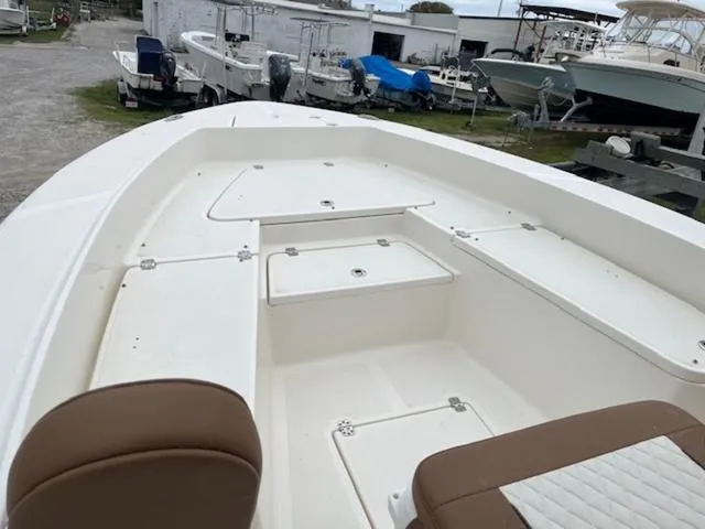 Slide: The Image of 2023 Pioneer 220 Bay Sport boat interior with storage compartments and seating. - 7