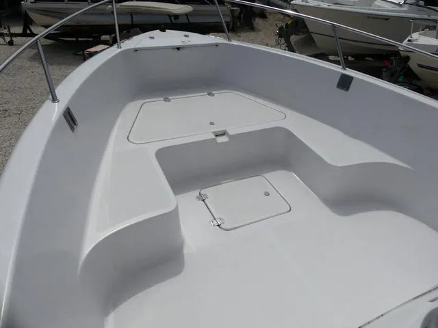 Slide: The Image of 2002 Pro-Line 22 Sport boat deck with storage compartments and railing. - 11