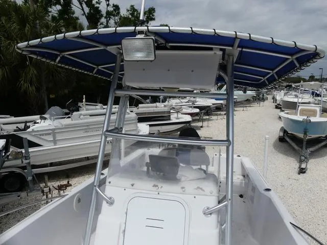 Slide: The Image of 2002 Pro-Line 22 Sport boat with blue canopy in a marina. - 14