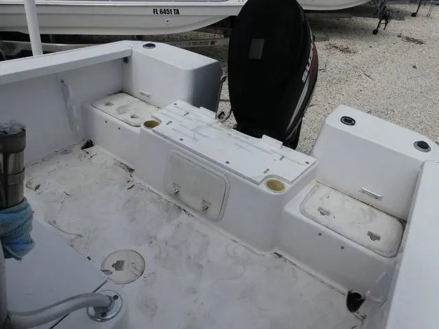 Slide: The Image of 2002 Pro-Line 22 Sport boat interior with storage compartments and outboard motor. - 15