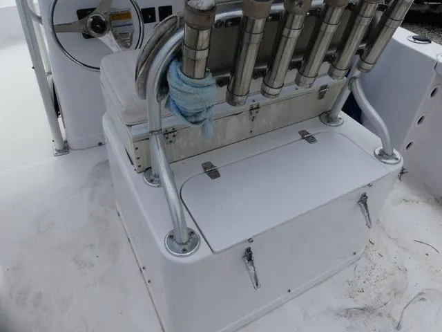 Slide: The Image of 2002 Pro-Line 22 Sport boat interior with rod holders and storage compartment. - 16