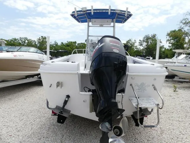 Slide: The Image of 2002 Pro-Line 22 Sport boat with outboard motor, parked on gravel. - 5
