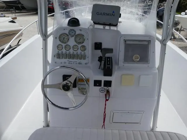 Slide: The Image of 2002 Pro-Line 22 Sport boat dashboard with Garmin navigation system and steering wheel. - 8