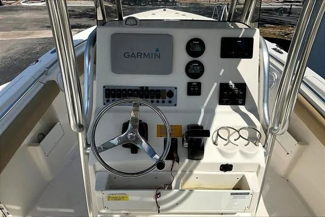 Slide: The Image of 2018 Key West 239FS boat console with Garmin navigation and steering wheel. - 11