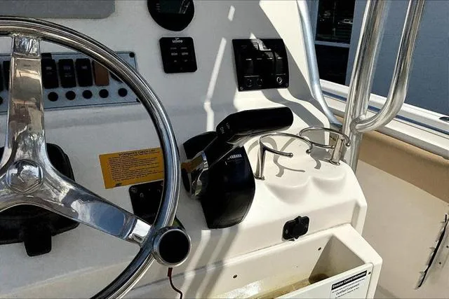 Slide: The Image of 2018 Key West 239FS boat dashboard with steering wheel and controls. - 12