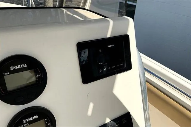 Slide: The Image of 2018 Key West 239FS boat dashboard with Yamaha gauges and Fusion audio system. - 15