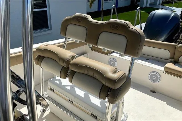 Slide: The Image of 2018 Key West 239FS boat interior with beige cushioned seating and stainless steel fixtures. - 17
