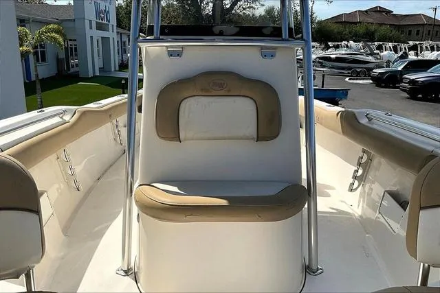 Slide: The Image of 2018 Key West 239FS boat interior with beige seating and console. - 18