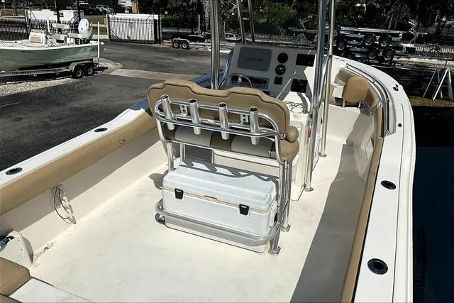 Slide: The Image of 2018 Key West 239FS boat interior with seating and console, parked outdoors. - 25