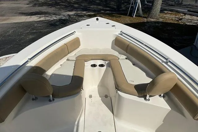 Slide: The Image of 2018 Key West 239FS boat with beige seating and spacious deck layout. - 29