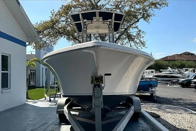 Slide: The Image of 2018 Key West 239FS boat on trailer, parked outdoors near buildings. - 34