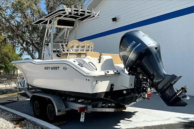 Slide: The Image of 2018 Key West 239FS boat on trailer with Yamaha outboard motor, parked outdoors. - 37