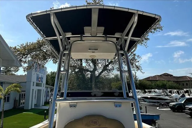 Slide: The Image of 2018 Key West 239FS boat with T-top, parked outdoors at a dealership. - 40