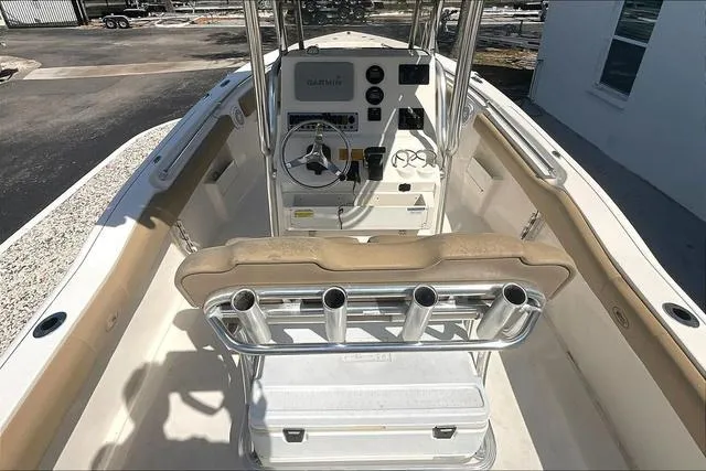 Slide: The Image of 2018 Key West 239FS boat interior with steering console and rod holders. - 42