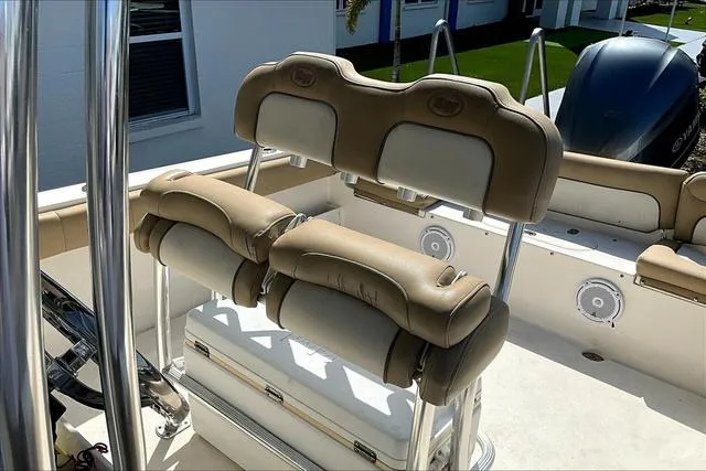 Slide: The Image of 2018 Key West 239FS boat interior with tan cushioned seating and stainless steel fixtures. - 49