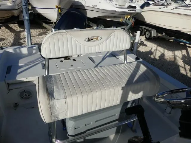 Slide: The Image of 2010 Sea Hunt BX 22 Pro boat interior with cushioned seating and control panel. - 12