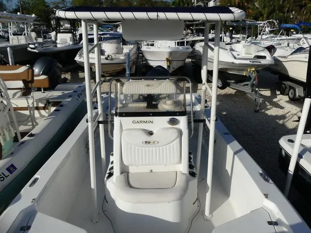Slide: The Image of 2010 Sea Hunt BX 22 Pro boat with Garmin equipment, docked among other boats. - 19