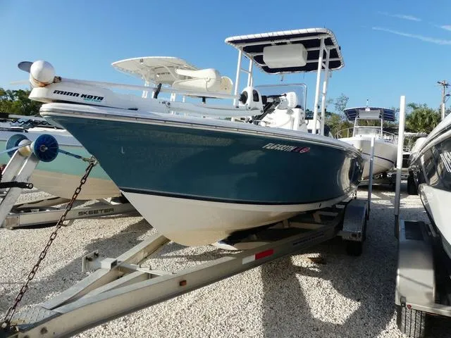 Slide: The Image of 2010 Sea Hunt BX 22 Pro boat on trailer, blue hull, parked outdoors. - 3