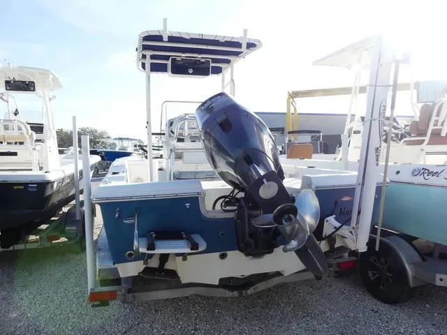 Slide: The Image of 2010 Sea Hunt BX 22 Pro boat with outboard motor, parked on gravel. - 5