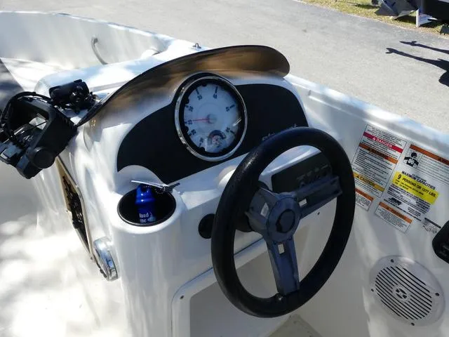 Slide: The Image of 2019 Bayliner Element E18 dashboard with steering wheel and gauges. - 4
