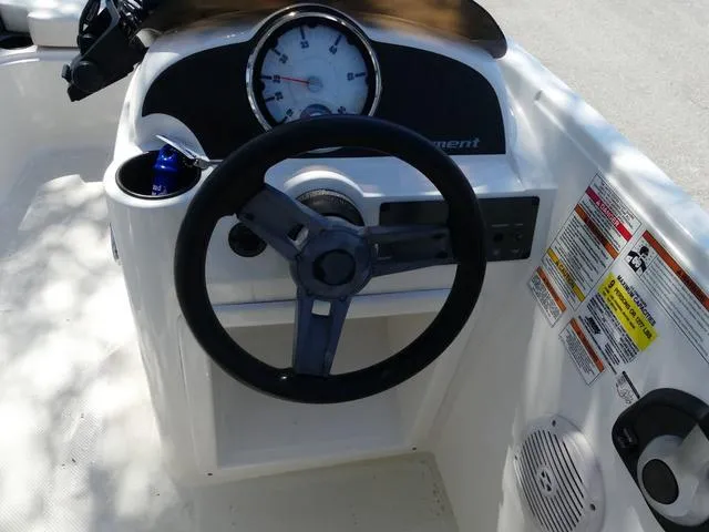 Slide: The Image of 2019 Bayliner Element E18 boat dashboard with steering wheel and gauges. - 5